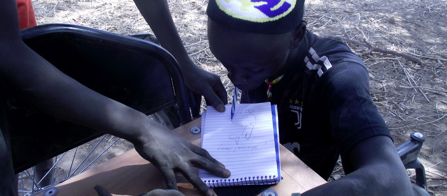 Photo: Image showing Lual, a 21-year-old disabled boy in Awiel
