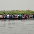 A boat carries civilians across the White Nile between Upper Nile state capital Malakal and the village of Wau Shilluk, on March 1, 2015. (AP Photo/Jason Patinki)