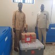 Unity State caretaker minister of health Stephen Tot Chieng and Dr. Banen medical director in Bentiu Hospital standing next to the J&J vaccines. [Photo: Radio Tamazuj]